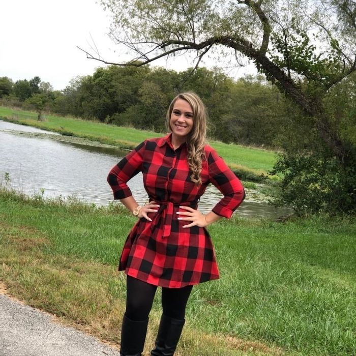 Reviewer dressed in a red plaid shirt dress.
