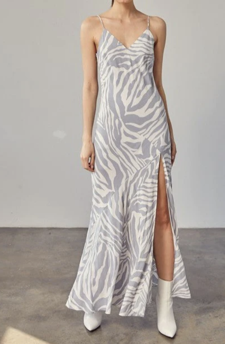 Model styled in the zebra print dress with white booties.