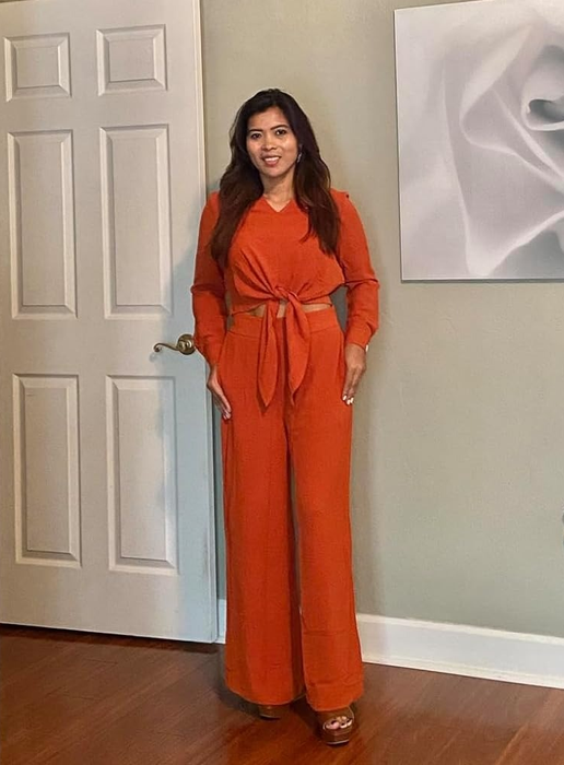 reviewer standing in an orange jumpsuit