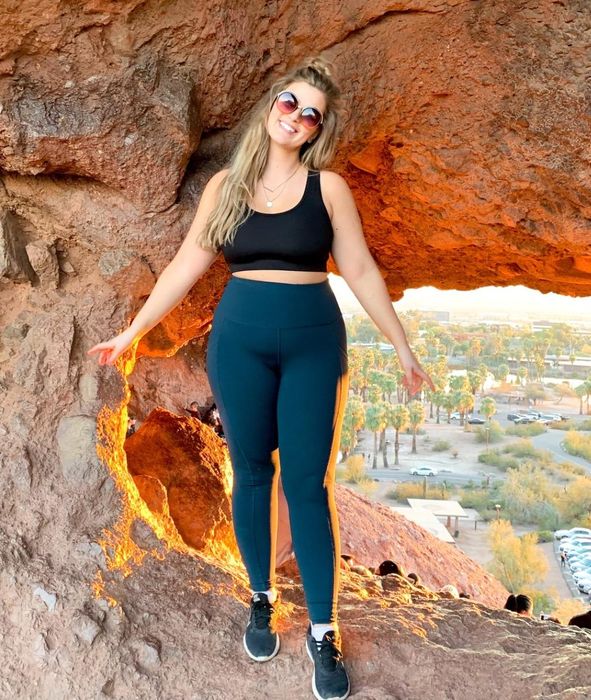 A reviewer showcasing the stylish green leggings