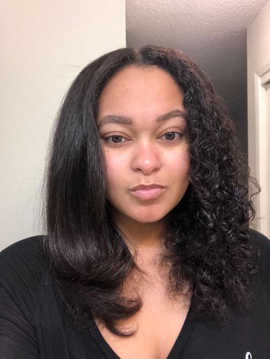 Reviewer displaying half-straight, half-curly hair, demonstrating the results of the hair product