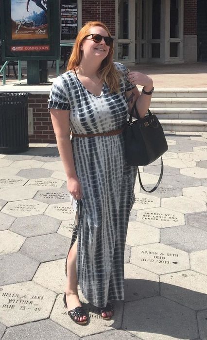 Reviewer wearing the blue tie-dye maxi dress, accessorized with a belt.