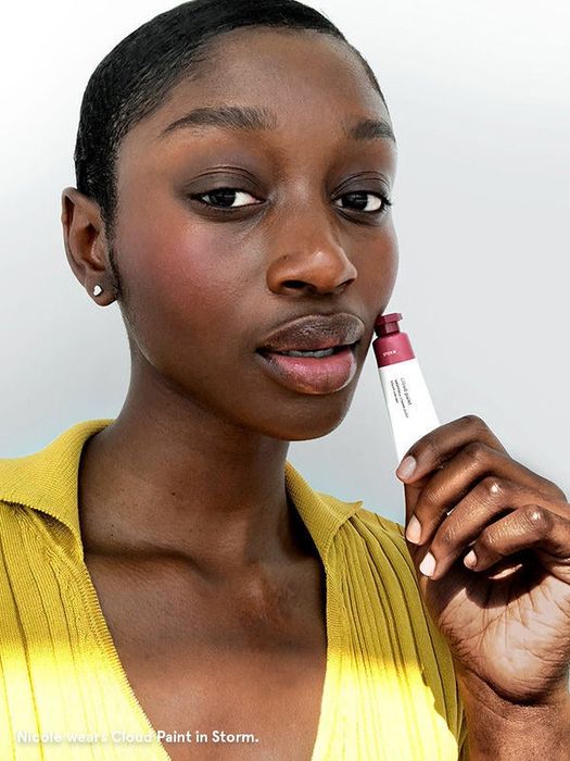 A model showcasing a dark pink blush from Cloud Paint applied to their cheeks