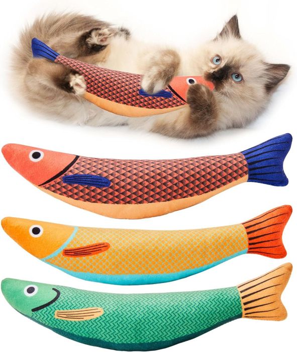 A cat plays with fish-shaped toys, while three additional fish-shaped toys are shown below.
