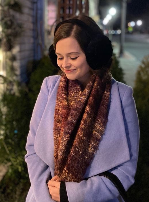 A reviewer modeling the black earmuffs