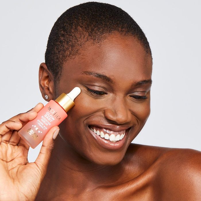 a model showcasing the serum bottle
