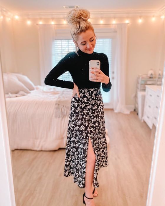 A reviewer wearing the sophisticated black floral skirt