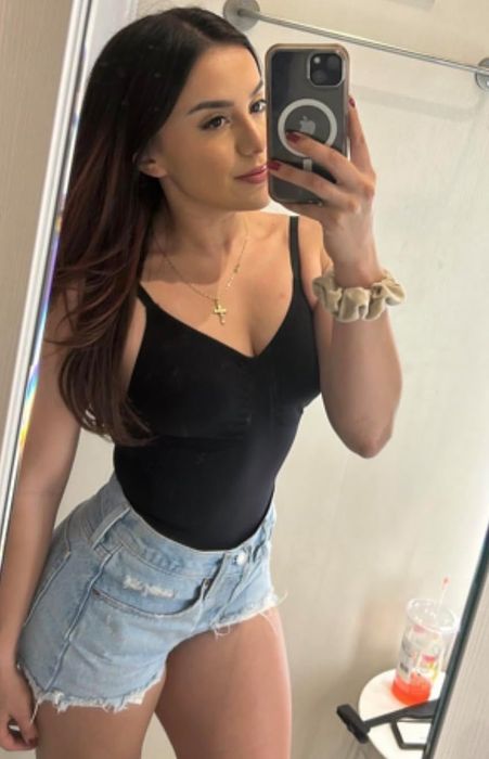 A reviewer wearing the black bodysuit