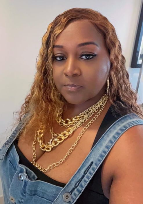 A reviewer showcasing the gold necklace