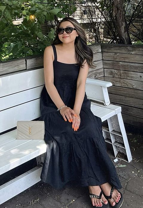 A reviewer wearing the black dress