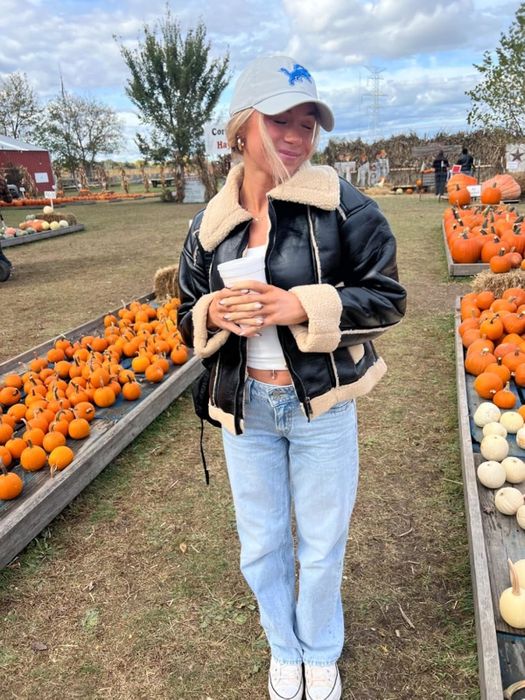 A reviewer showcasing the light wash jeans