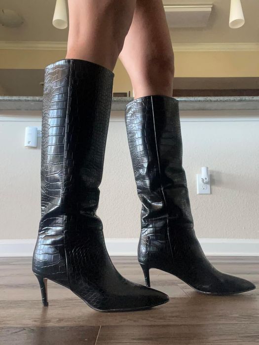 Black knee-high boots with a crocodile texture, pointed toes, and slender heels