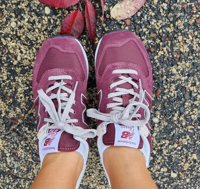 a reviewer sporting the shoes in a rich burgundy color