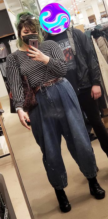 A reviewer styling the pants with a belt for a polished look.