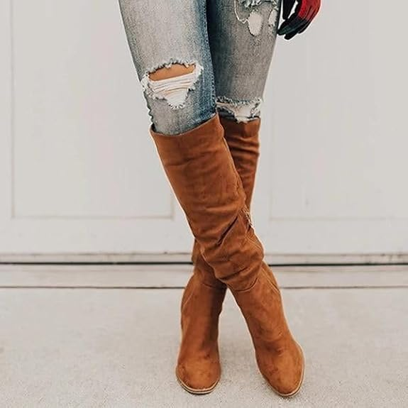 Distressed jeans paired with brown suede knee-high boots