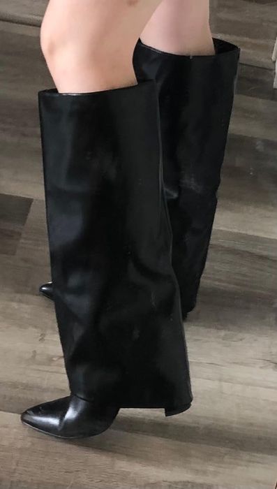 Chic foldover black knee-high boots with pointed toes on display