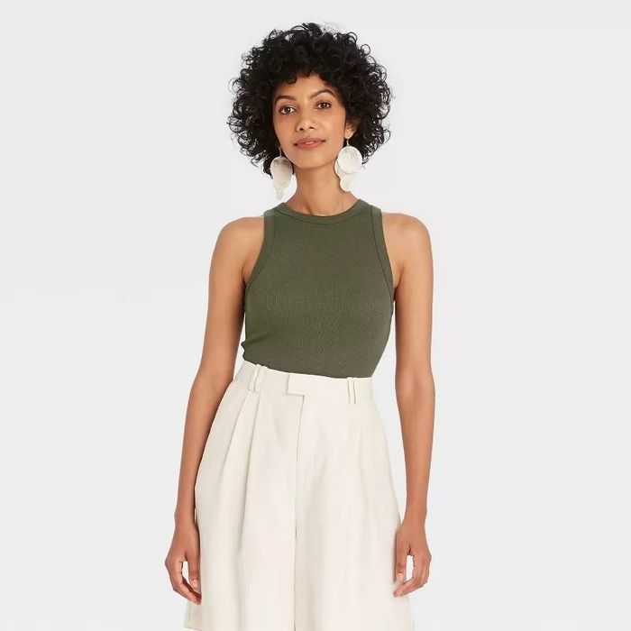 A model styled in a sleeveless top paired with wide-leg trousers