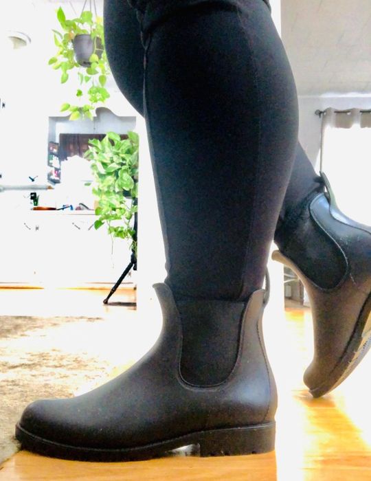 A side view of a reviewer’s feet wearing the boots with black jeans tucked into them