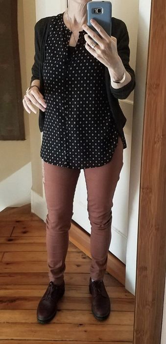 A reviewer snapping a selfie while wearing brick-colored pants.