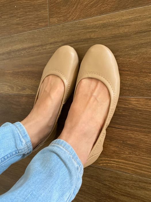 The same reviewer showcasing the beige flats