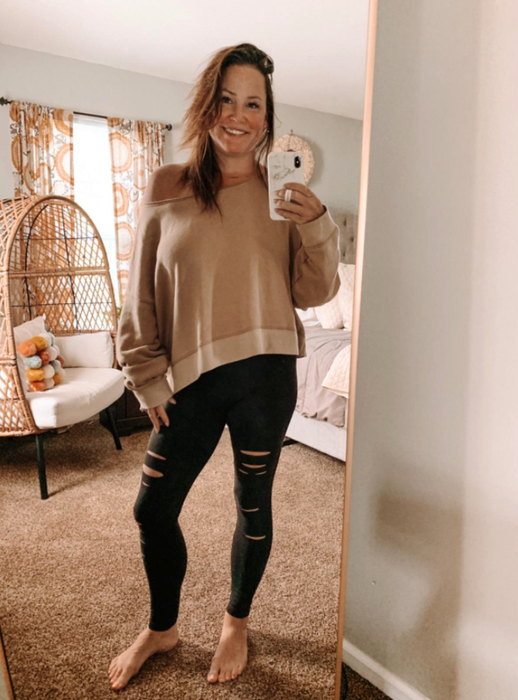 Another reviewer styling the leggings with an off-the-shoulder sweater