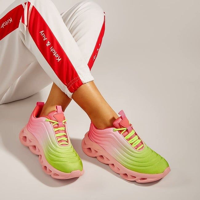 A model wearing pink and neon green ombre chunky sneakers
