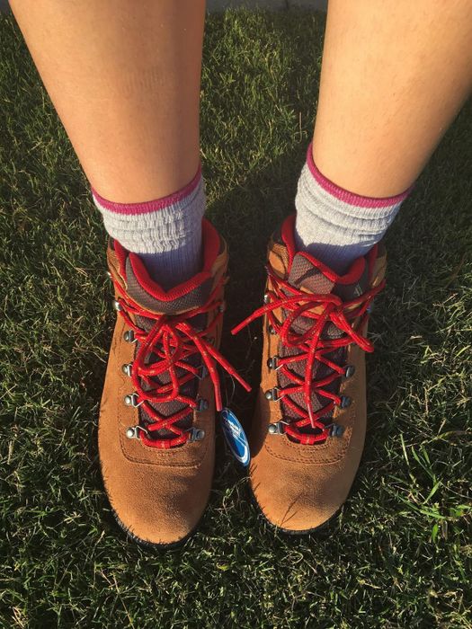 A close-up shot of another reviewer wearing the same pair of boots