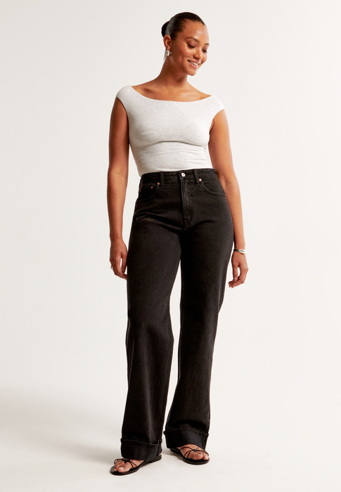 A person showcasing a fitted top paired with wide-leg jeans, perfect for a shopping guide segment.