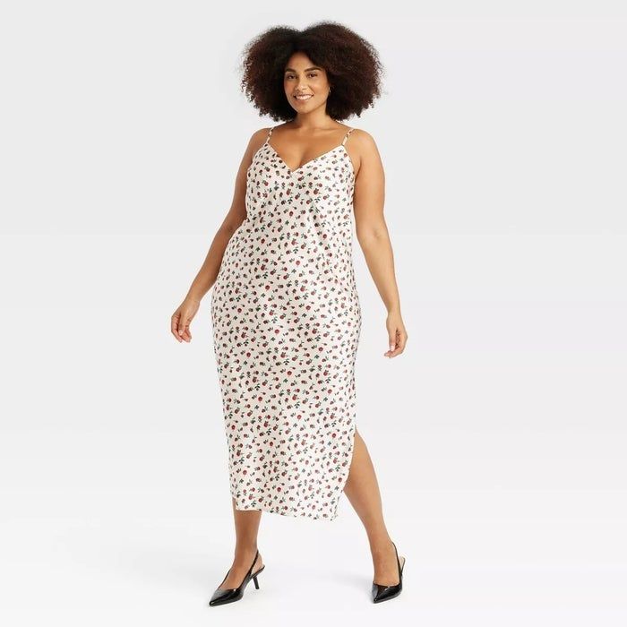 A model showcases a sleeveless, floral maxi dress paired with black heels