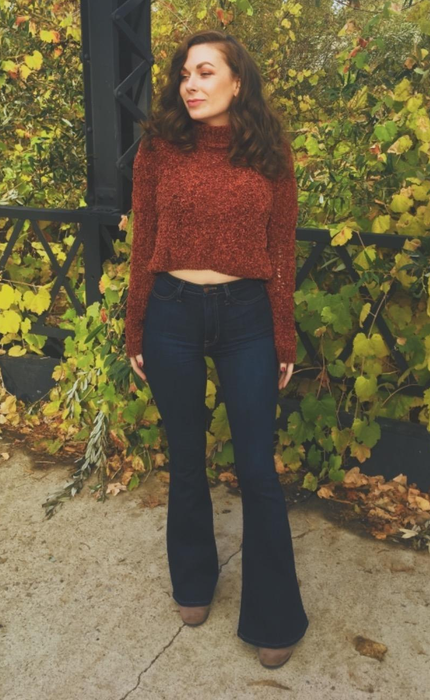 A reviewer is seen wearing the jeans, showcasing their fit and style.