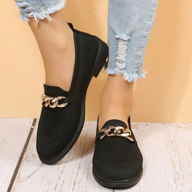 A close-up of a model wearing the loafers