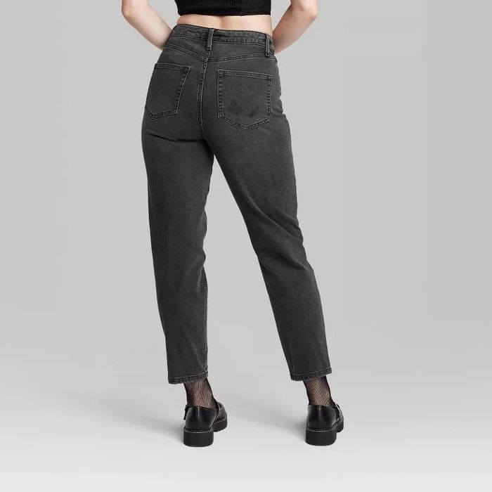 A model showcasing the back view of high-rise black wash denim jeans