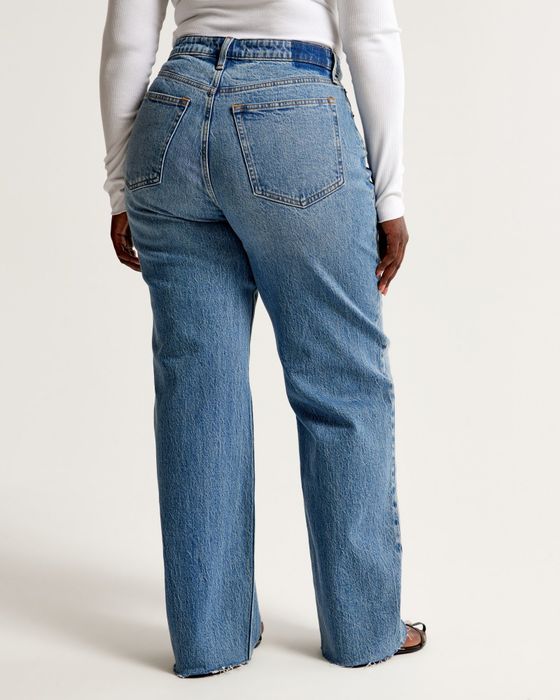 A person wearing high-waisted straight-leg jeans and a fitted white top, shown from the back, ideal for a fashion shopping feature.