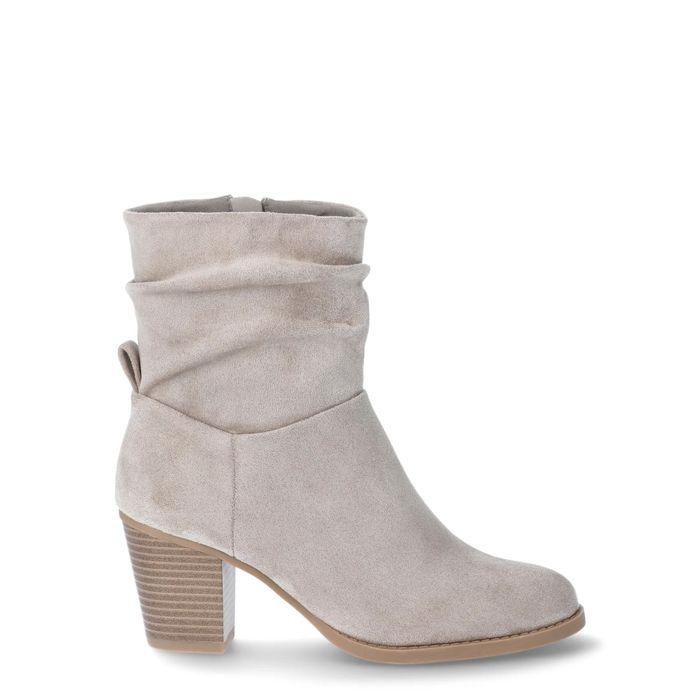 A suede ankle boot featuring a stacked block heel and a relaxed slouchy design; highlighted in a shopping feature