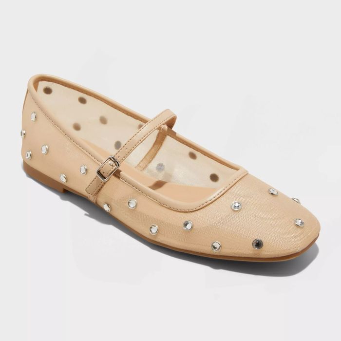 Beige mesh ballet flats featuring a strap and adorned with small, round rhinestones, ideal for both casual and semi-formal occasions