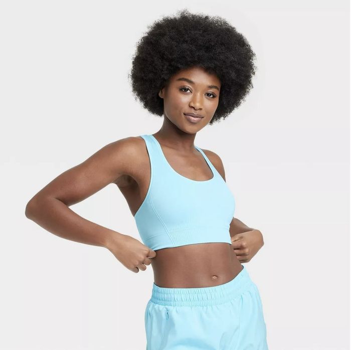 A model wearing an aqua blue sports bra