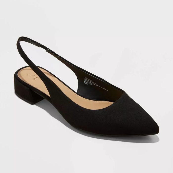 A single black slingback flat shoe with a pointed toe design and a low block heel.