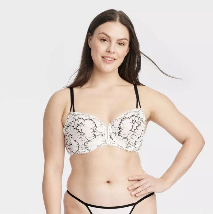A model striking a pose in a floral-patterned bra paired with matching underwear