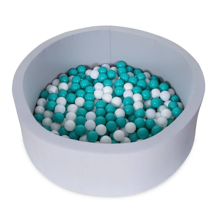 A round ball pit filled with teal and white plastic balls, perfect for children’s play spaces
