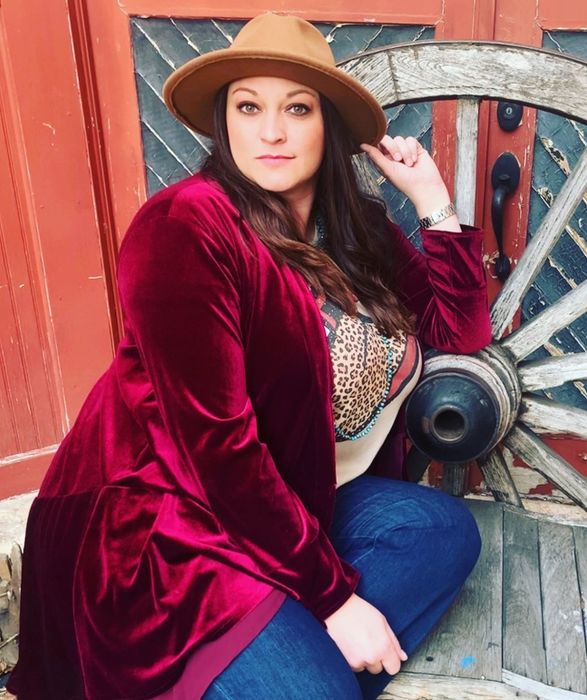 reviewer wearing the red jacket paired with jeans