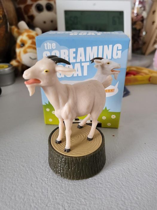 A screaming goat figurine on a display stand, boxed with a playful design; highlighted in a shopping article