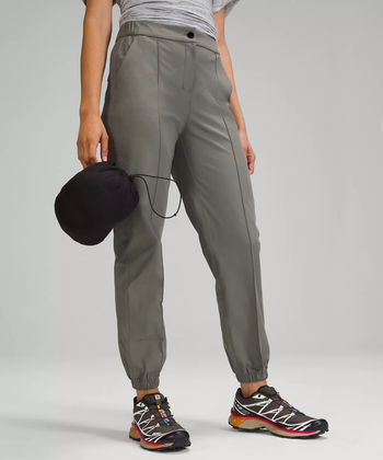 Model holding the jacket in its compact carrying bag