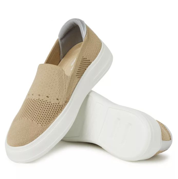 A pair of slip-on sneakers with textured fabric against a white background