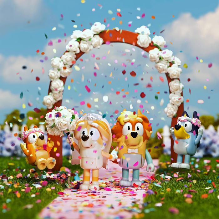 Animated characters celebrate a wedding under a floral arch, with confetti falling around them, creating a joyous and festive atmosphere.