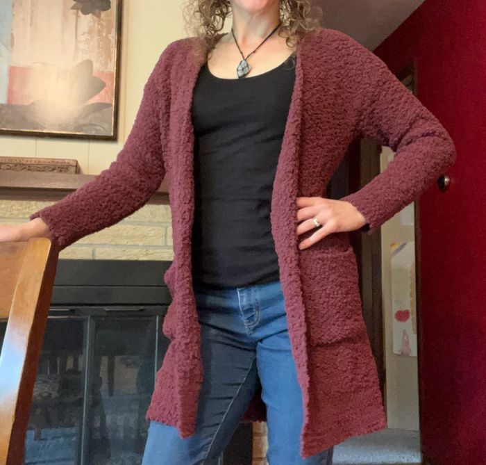 Reviewer showcasing a maroon sweater