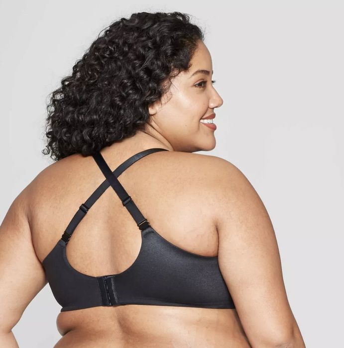 A model wearing a black bra featuring crisscross back straps