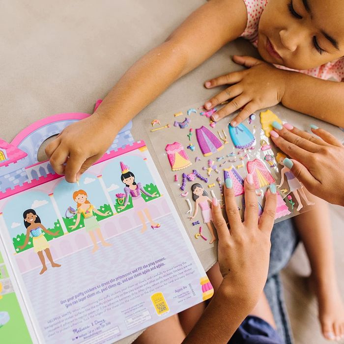 A group of children enjoying the princess-themed sticker activity book.