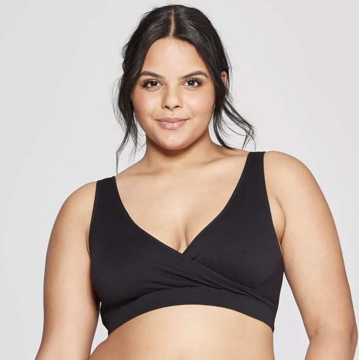 A model wearing a sleek black seamless sleep nursing bra