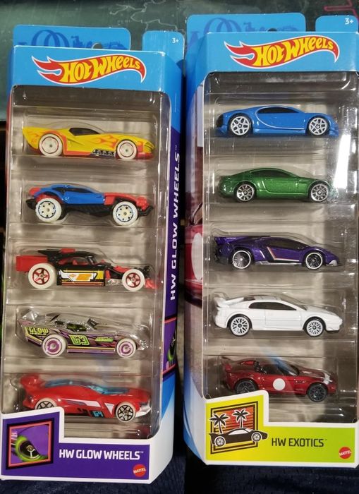 Hot Wheels car packs featuring eight miniature vehicles from the HW Glow Wheels and HW Exotics series, elegantly displayed in clear packaging for an exciting, detailed showcase.