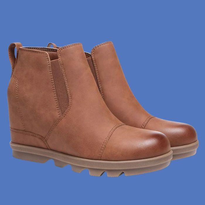 Brown faux leather wedge ankle boots with elastic side panels and rugged soles, ideal for autumn and winter fashion, showcased against a simple background.